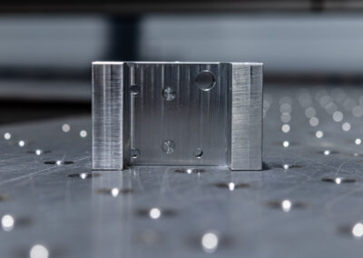 Aluminiumbauteil mit unterschiedlichen Bohrungen und Fräsungen