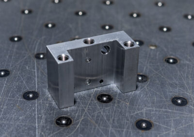 Aluminiumbauteil mit unterschiedlichen Bohrungen und Fräsungen