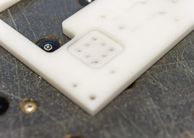 Kunststoffteil mit unterschiedlichen Bohrungen und Fräsungen